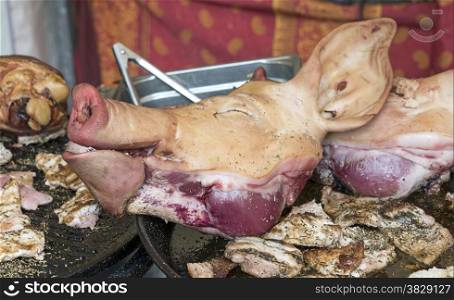 pigs head with ears and nose as food on the market