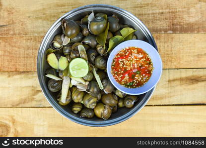 Pila ampullacea shellfish freshwater snail nautilus ammonite with spicy chili sauce / Boiled golden apple snail river cooked for Asian food in Thailand