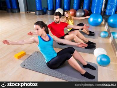 Pilates people group exercise man and women at fitness gym
