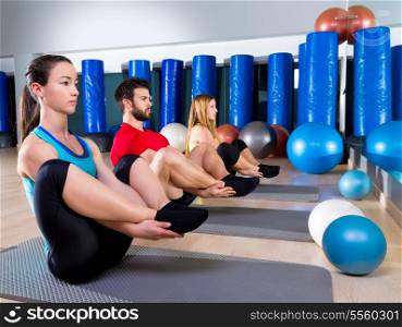 Pilates people group the seal exercise man and women at fitness gym