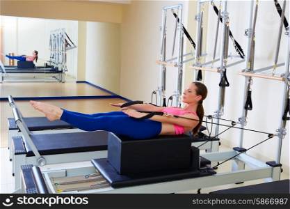 Pilates reformer woman back stroke exercise workout at gym indoor