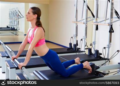 Pilates reformer woman down stretch exercise workout at gym indoor