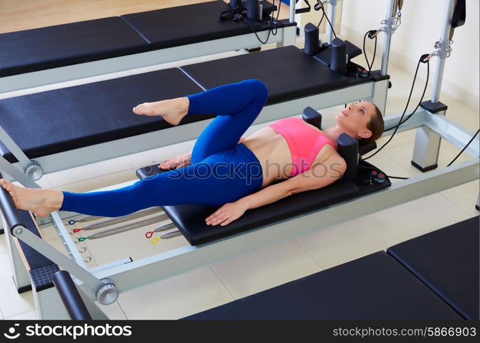 Pilates reformer woman foot work exercise workout at gym indoor