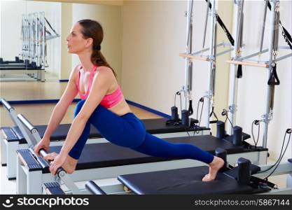 Pilates reformer woman front split exercise workout at gym indoor