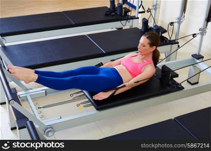 Pilates reformer woman hundred exercise workout at gym indoor
