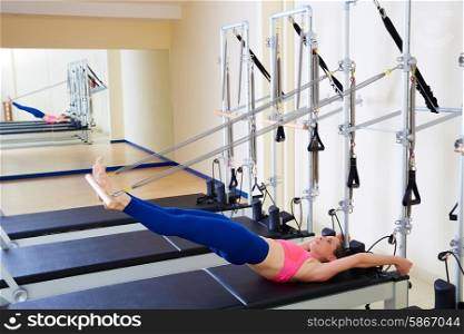 Pilates reformer woman long spine exercise workout at gym indoor
