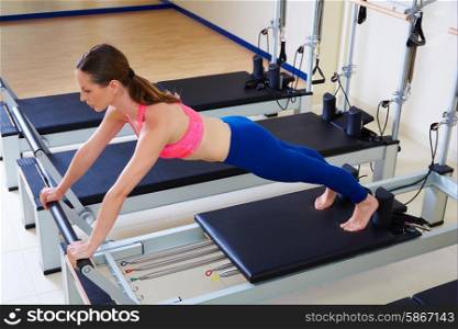 Pilates reformer woman long stretch exercise workout at gym indoor