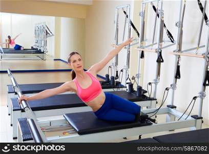Pilates reformer woman mermaid exercise workout at gym indoor