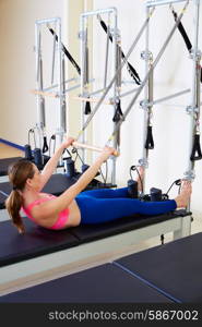Pilates reformer woman roll up exercise workout at gym indoor