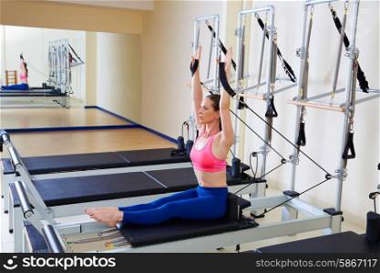 Pilates reformer woman rowing row exercise workout at gym indoor