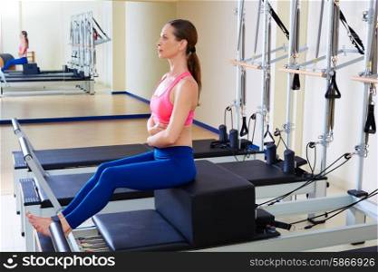 Pilates reformer woman short box exercise workout at gym indoor