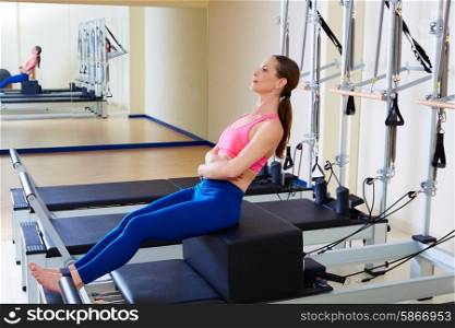 Pilates reformer woman short box flat exercise workout at gym indoor