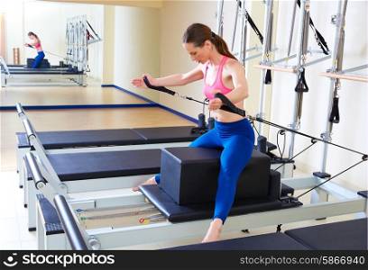Pilates reformer woman short box horse back exercise workout at gym
