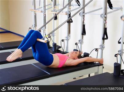 Pilates reformer woman short spine exercise workout at gym indoor