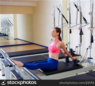 Pilates reformer woman stomach massage flat exercise workout at gym