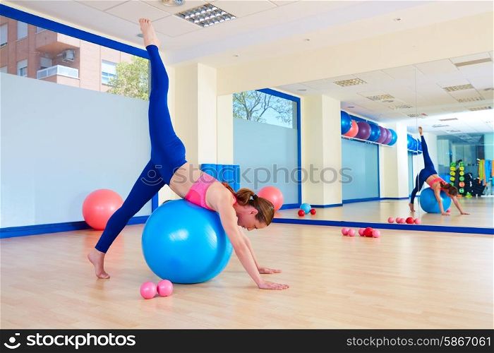 Pilates woman fitball arabesque exercise workout at gym indoor