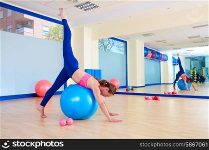 Pilates woman fitball arabesque exercise workout at gym indoor