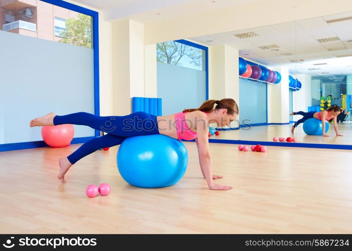 Pilates woman fitball leg pull front exercise workout at gym indoor