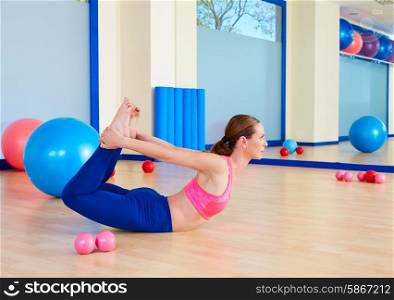 Pilates woman fitball rocking exercise workout at gym indoor