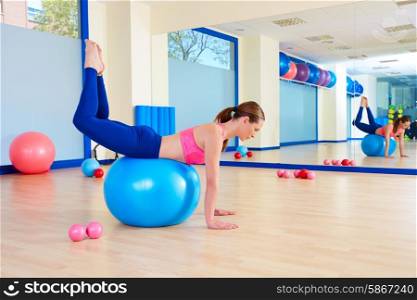 Pilates woman fitball rocking exercise workout at gym indoor