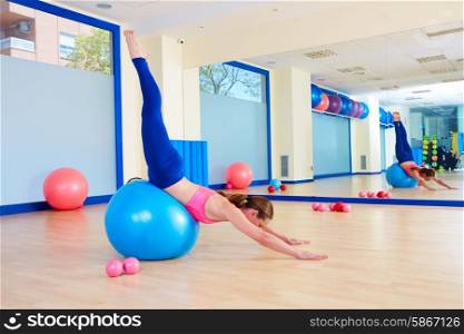 Pilates woman fitball swan dive exercise workout at gym indoor