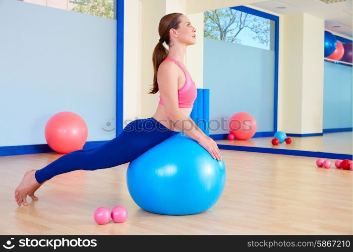 Pilates woman fitball swan exercise workout at gym indoor