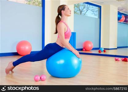 Pilates woman fitball swan exercise workout at gym indoor