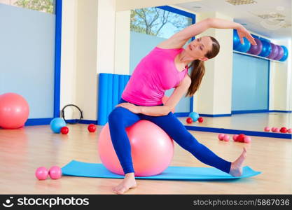 Pilates woman fitball swiss ball exercise workout at gym indoor