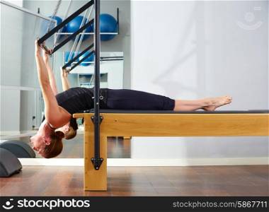 Pilates woman in reformer exercise at gym indoor