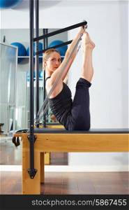 Pilates woman in reformer monki exercise at gym indoor