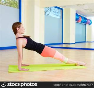 Pilates woman leg pull back exercise workout at gym indoor