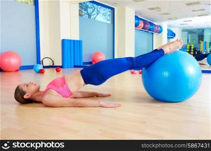 Pilates woman pelvic lift fitball exercise workout at gym indoor swiss ball