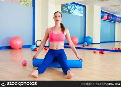 Pilates woman roller sit roll exercise workout at gym indoor