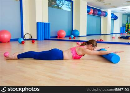 Pilates woman roller swan roll exercise workout at gym indoor
