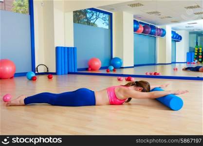 Pilates woman roller swan roll exercise workout at gym indoor