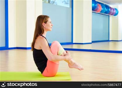 Pilates woman rolling like a ball exercise workout at gym indoor