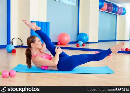 Pilates woman scissor exercise workout at gym indoor