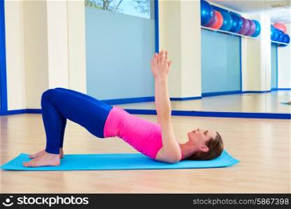 Pilates woman shoulder bridge exercise workout at gym indoor