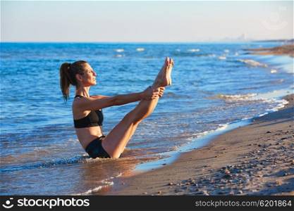 Pilates yoga workout exercise outdoor on the beach sand