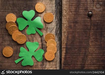 pile coins green paper shamrocks wooden table