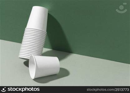pile cups leaning wall