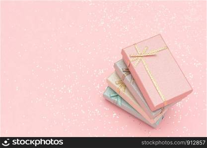 Pile gift boxes of pastel colors on pink background, Top view.. Pile gift boxes of pastel colors on pink background, Top view