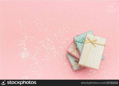 Pile gift boxes of pastel colors on pink background, Top view Copy space.. Pile gift boxes of pastel colors on pink background, Top view Copy space