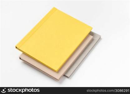 Pile multicolor hardcover books on white background. book album on a white background