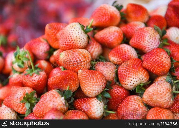 Pile od ripe strawberry for sale in the market fruit / harvested fresh strawberries background