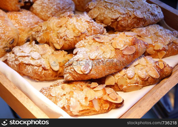 pile of almond croissant bread on buffet line