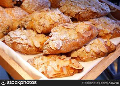 pile of almond croissant bread on buffet line