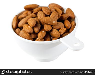 Pile of almond nuts in a measuring cup or bowl ready as a snack