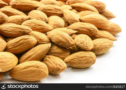 Pile of almonds on a white background in close-up.