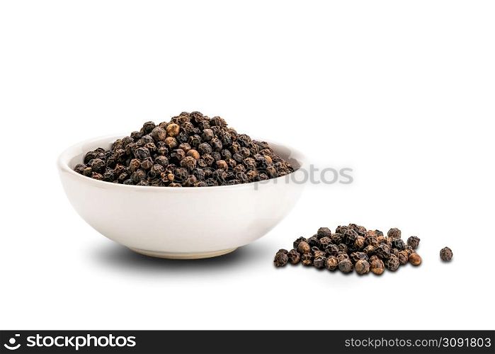 Pile of black pepper seeds and black pepper seeds in white ceramic cup isolated on white background with clipping path.